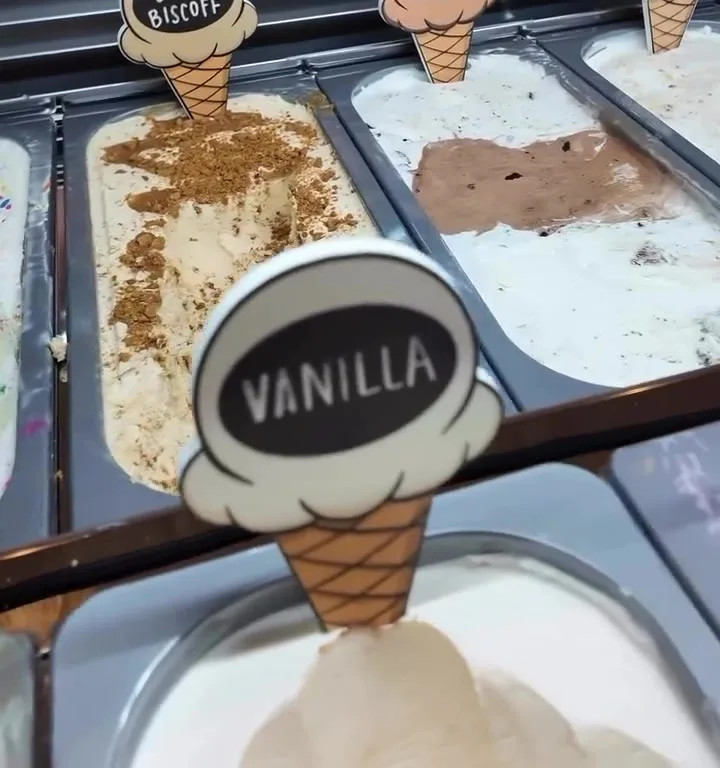 The Harvy's ice cream case, with cone-shaped flavor markers including Vanilla.