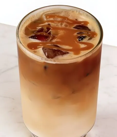 An iced caramel latte in a tall glass.